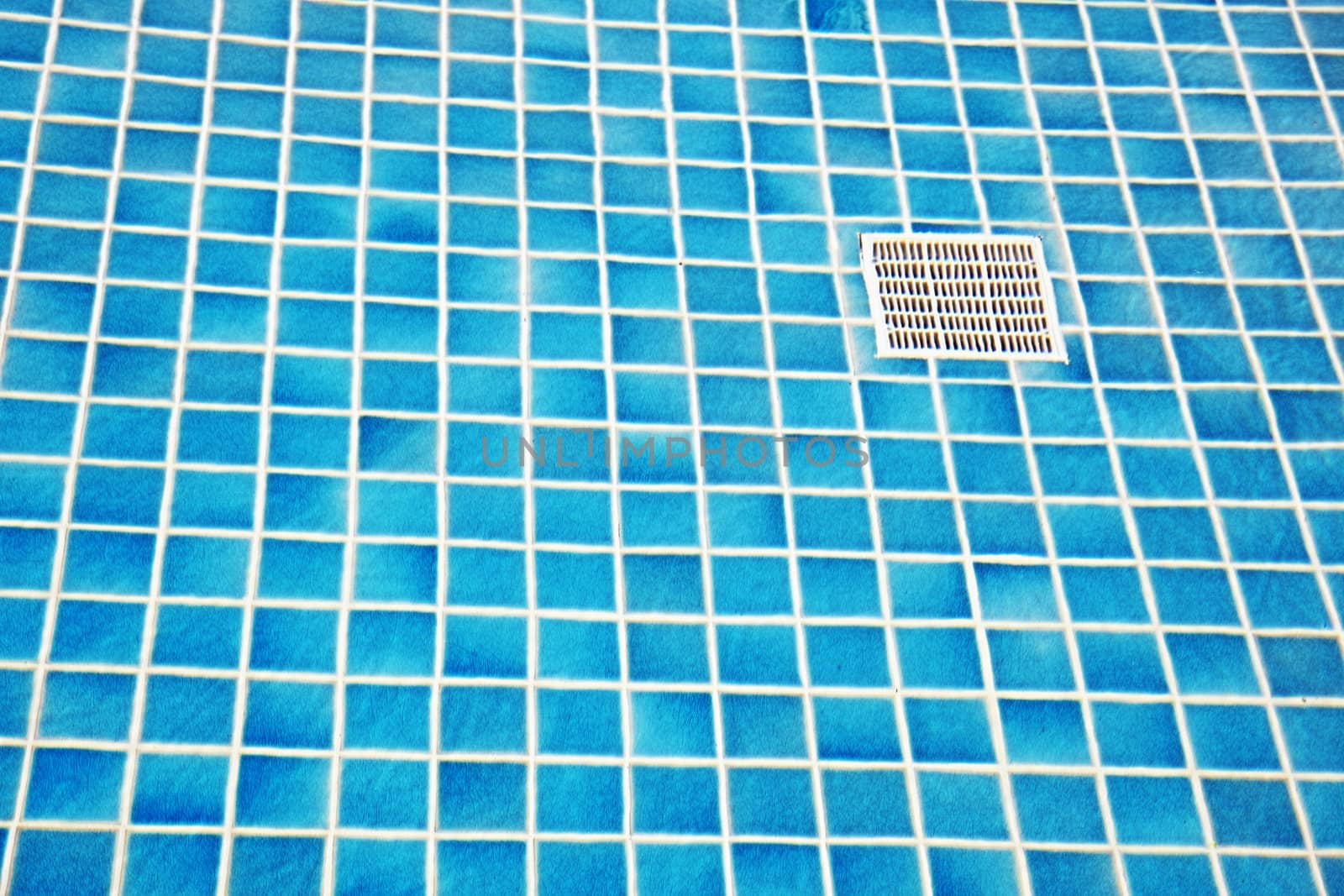 Blue tile on bottom of a swimming pool by pzaxe