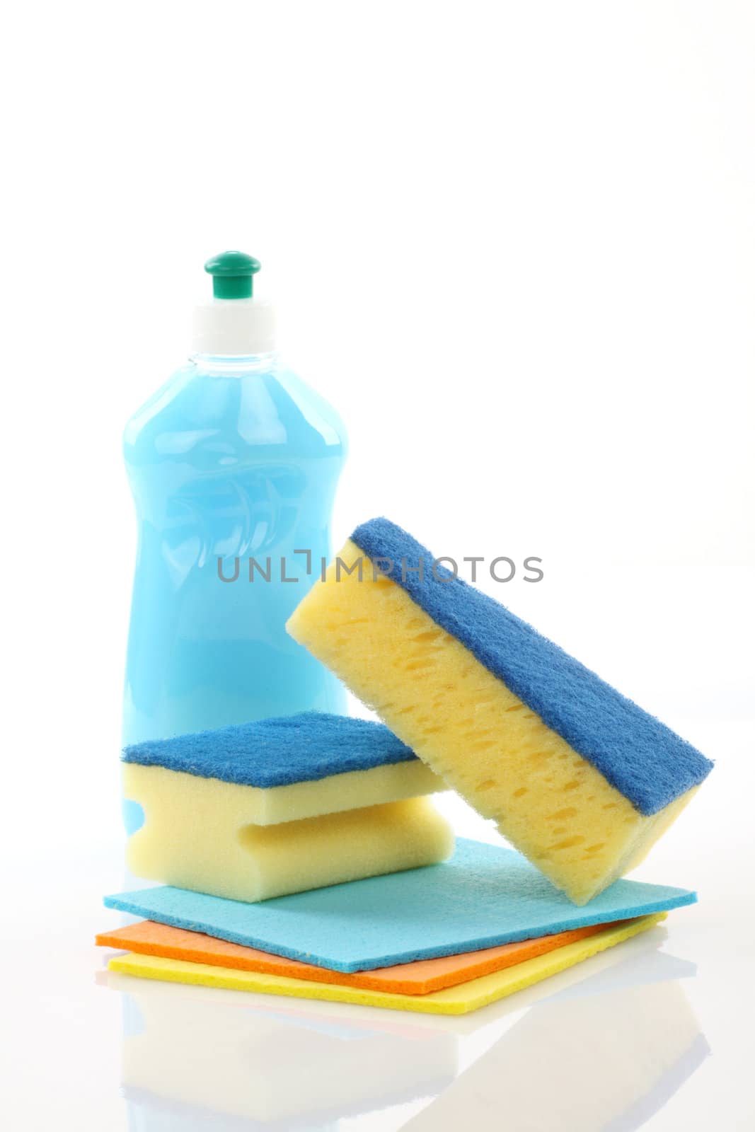 Bottle and sponges close up over white