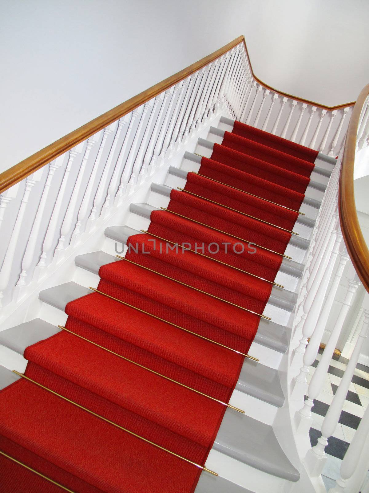 Nice old staircase with red carpet.