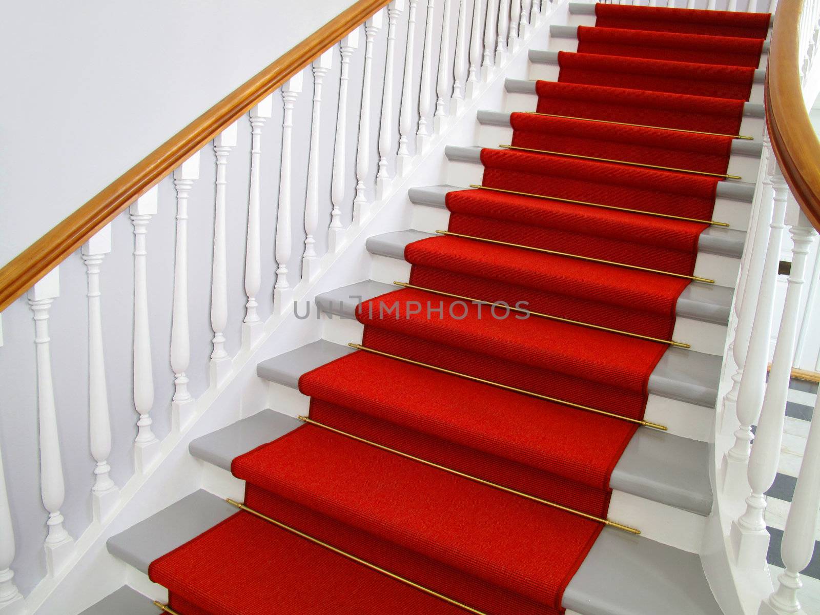 Nice old staircase with red carpet.