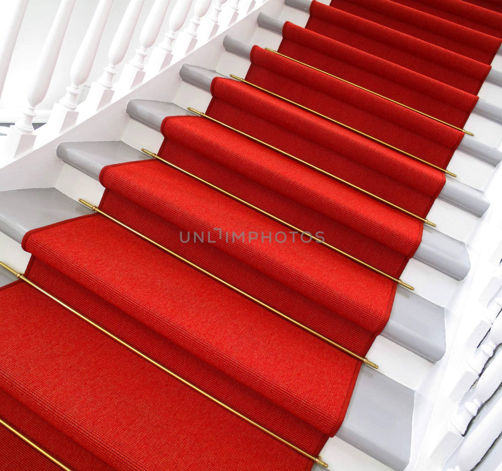 Nice old staircase with red carpet.