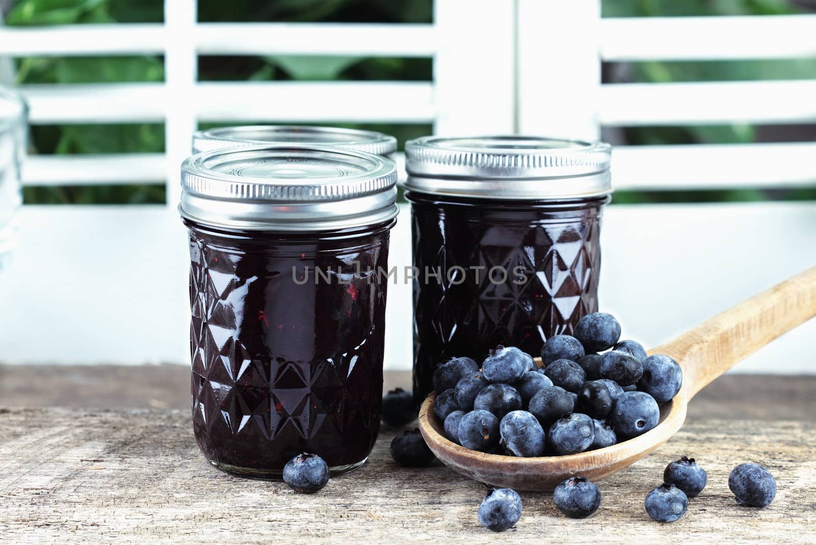Homemade blueberry jam or preserves with fresh blueberries.
