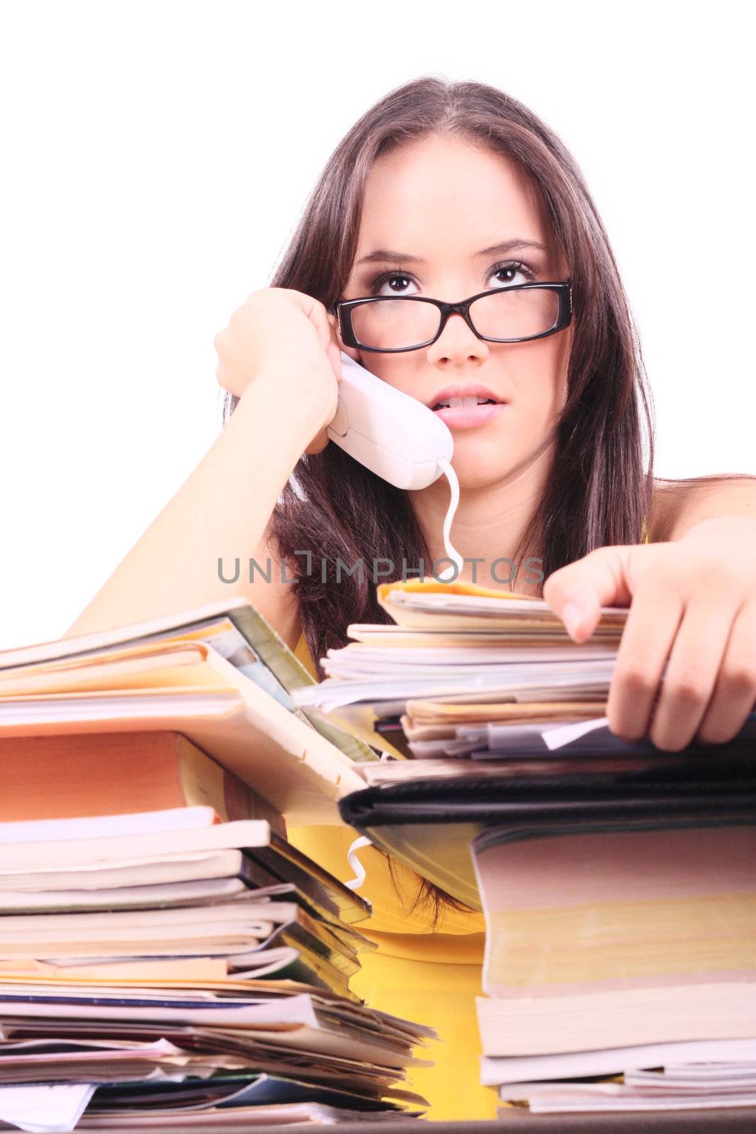 Stressed young businesswoman with telephone in her hand.