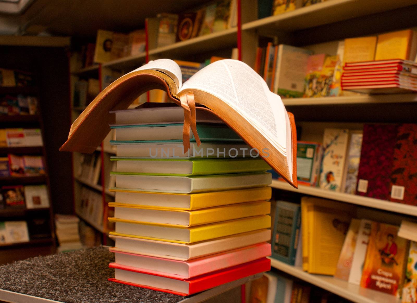 Open book on the stack of colorful books