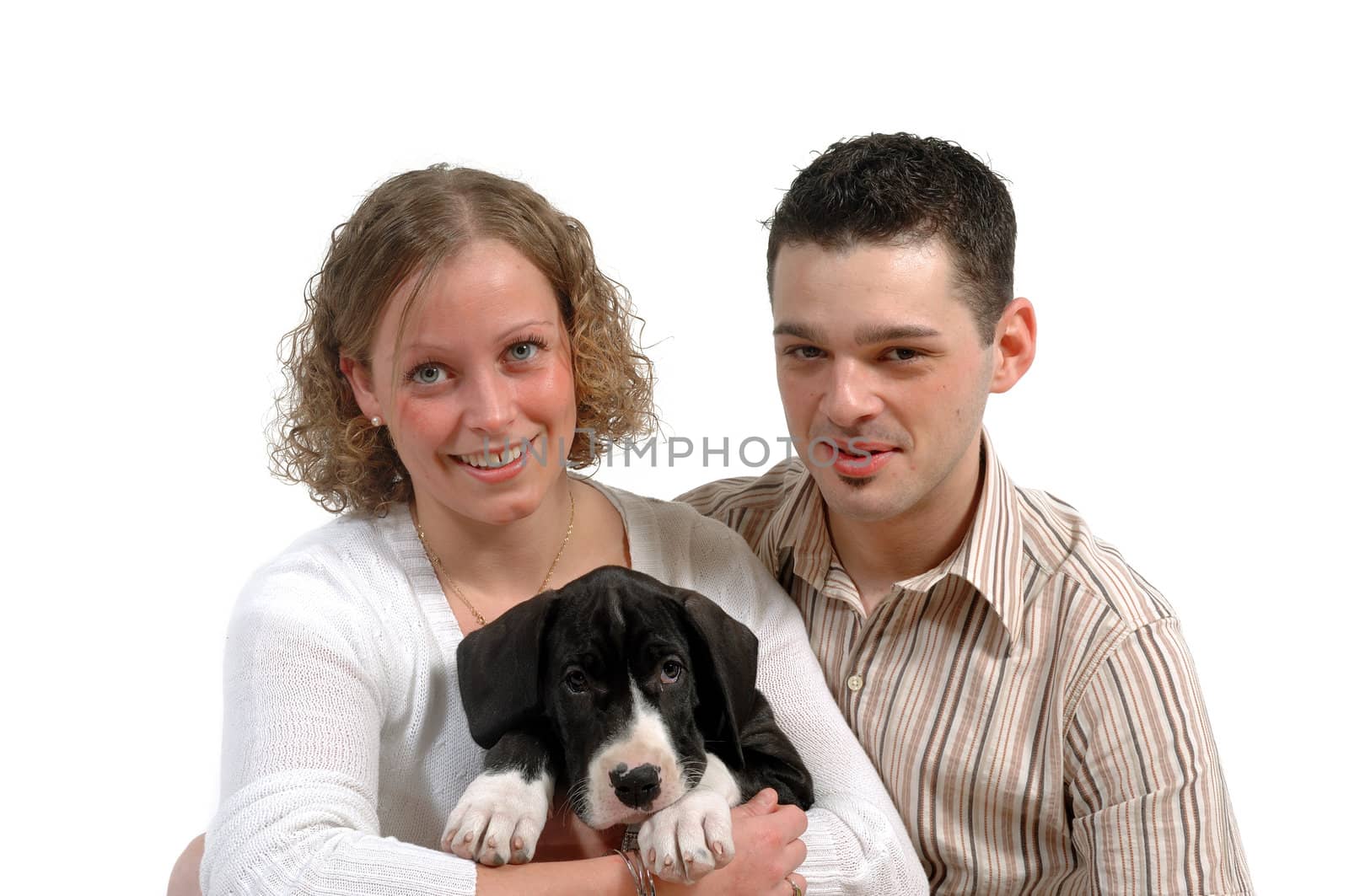Young smiling couple and a their sweet puppy.
