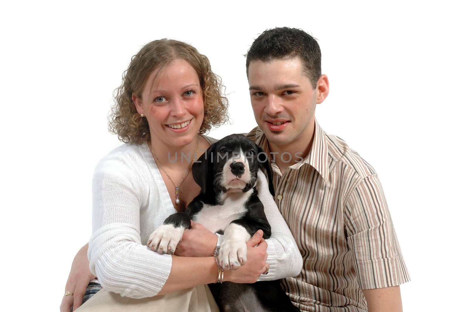 Young happy couple and sweet puppy