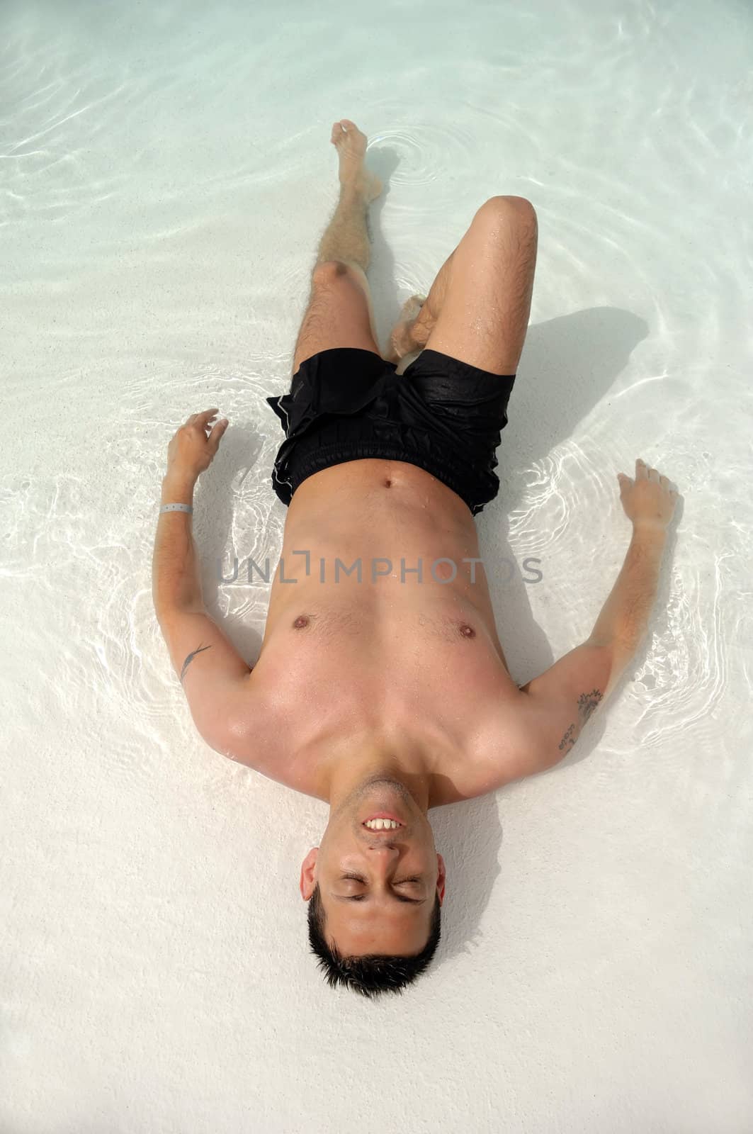 A man is relaxing in swimming pool