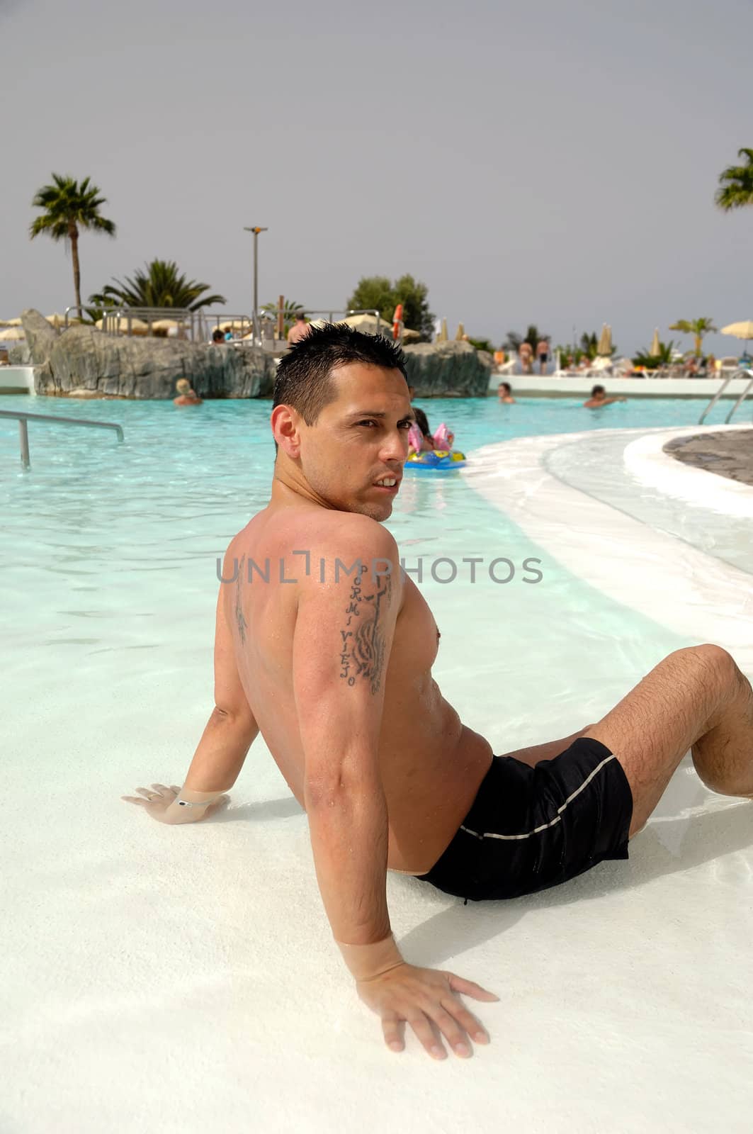 A man is relaxing in swimming pool