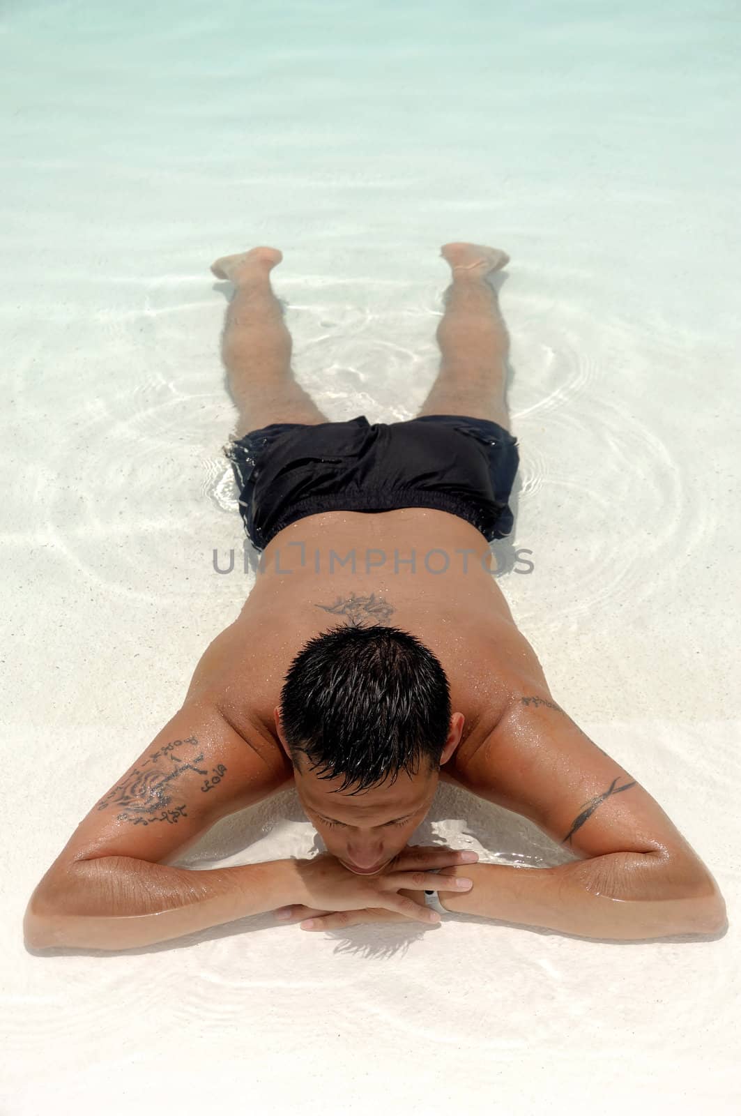 A man is relaxing in swimming pool