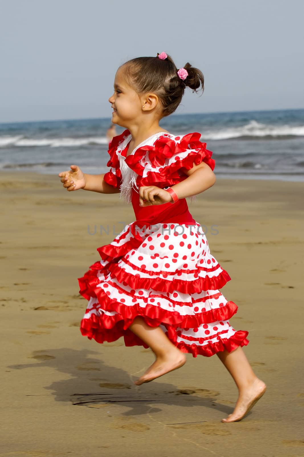 Happy child running on beach by cfoto