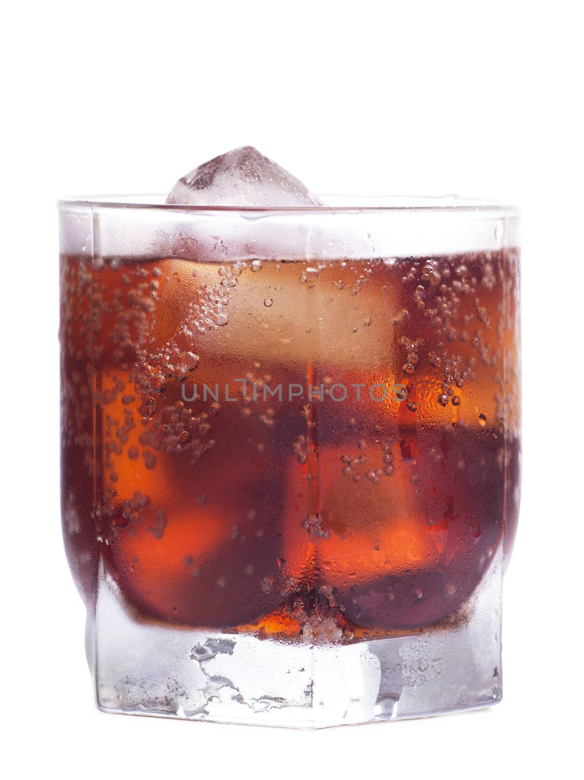 Cold cola in a glass with ice cubes over white background