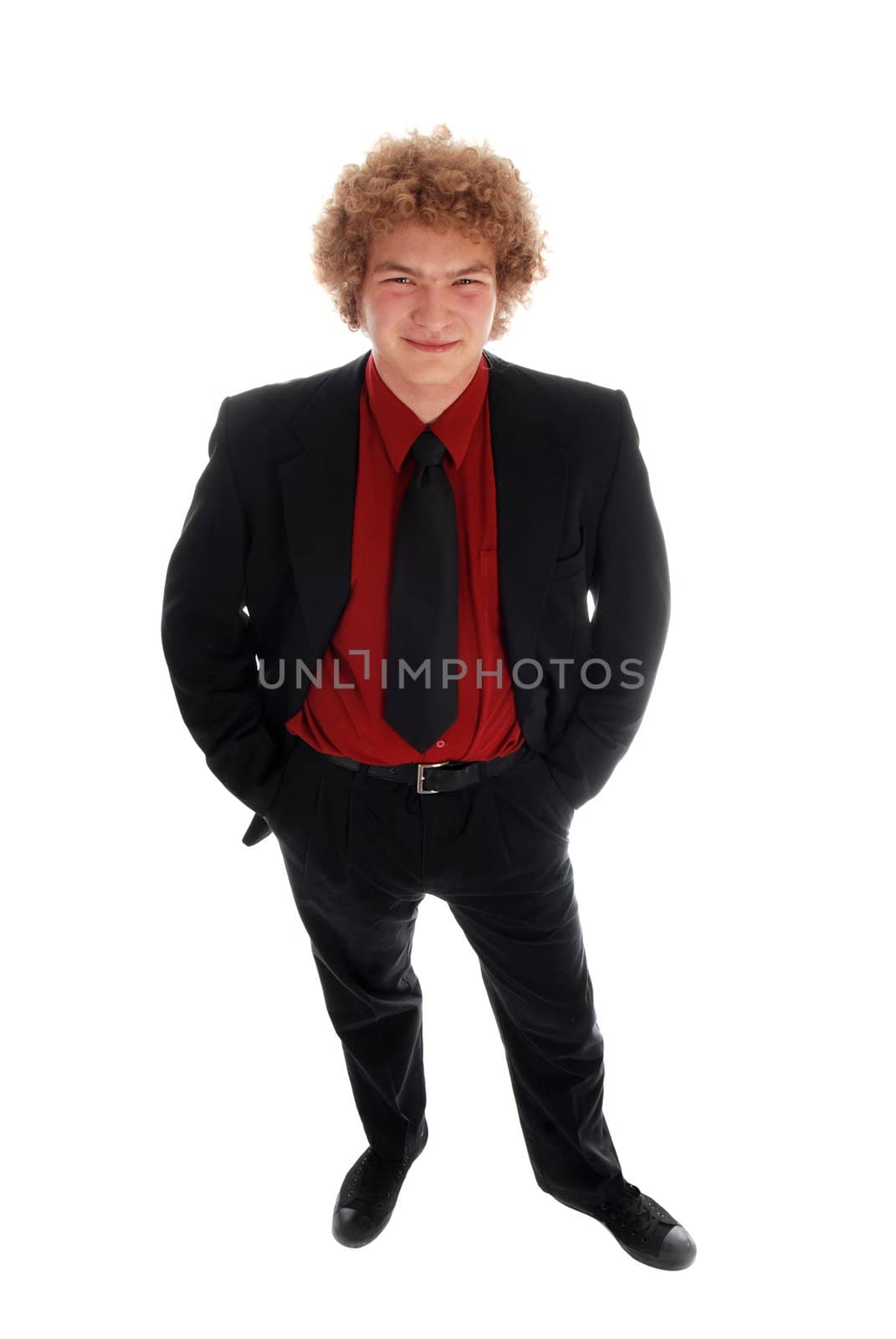 Young businessman standing in a black suit on white
