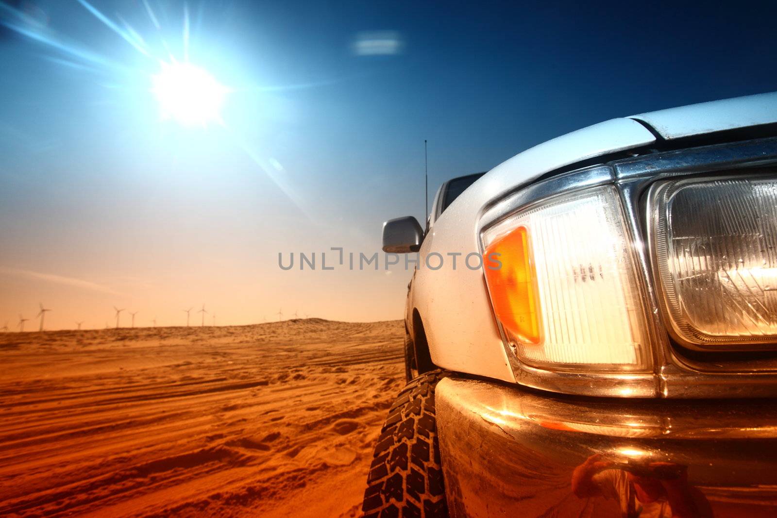 truck in desert sand and blue sky