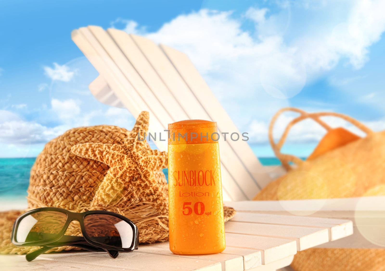 Sunblock lotion and beach items on table  by Sandralise