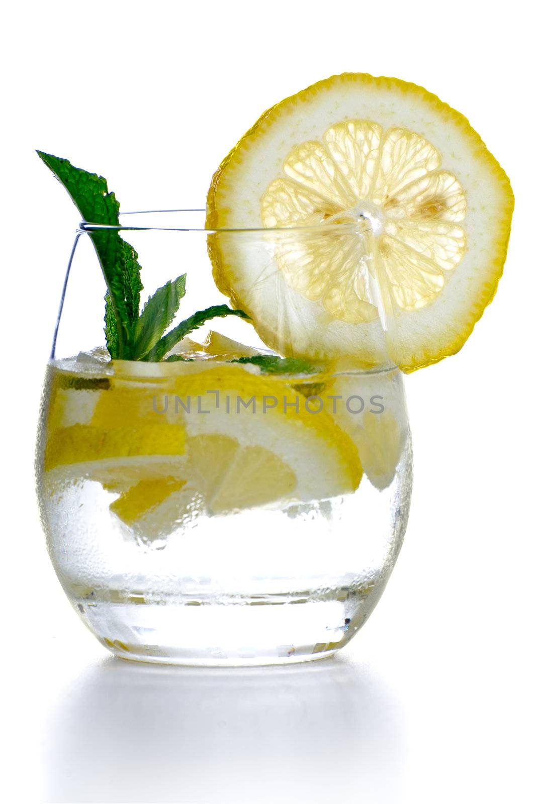 Glass of fresh cool drink with lime fruits isolated on white background.