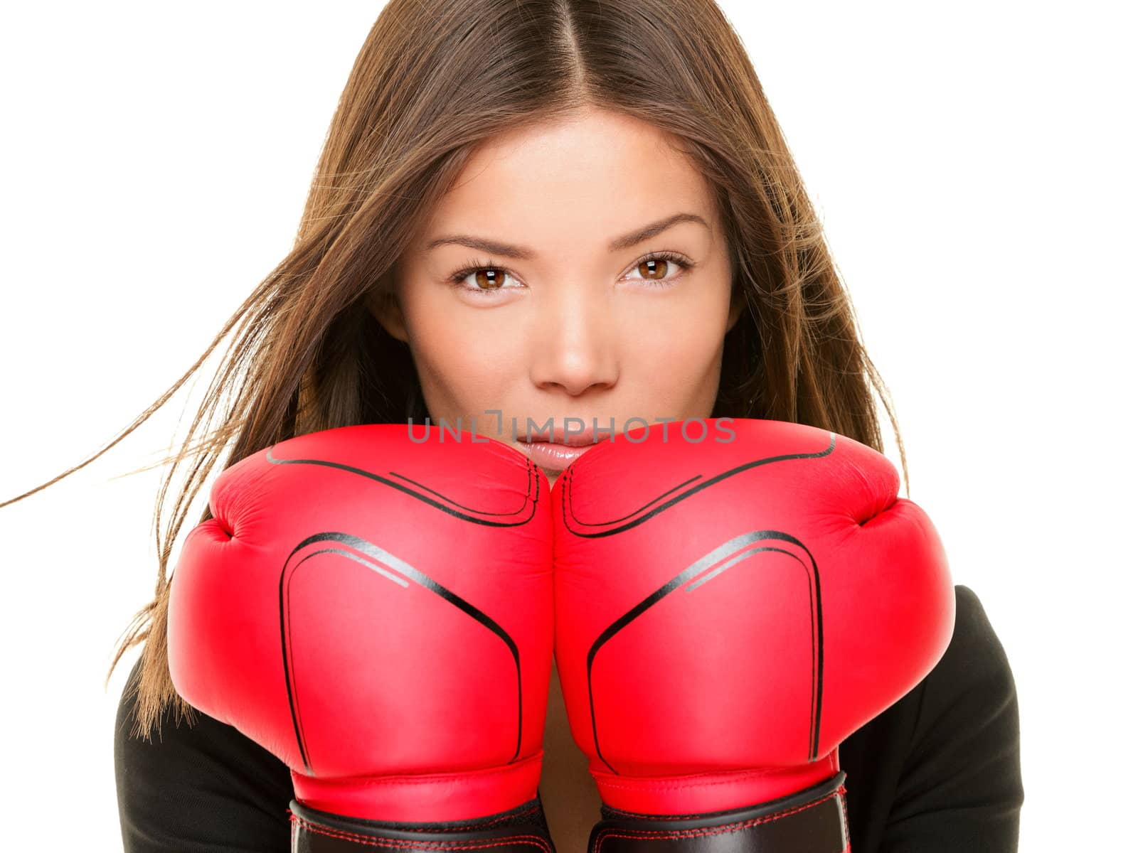 Businesswoman wearing boxing gloves ready to fight. Strength, power or competition concept image of beautiful young mixed race Chinese Asian / Caucasian business woman isolated on white background.