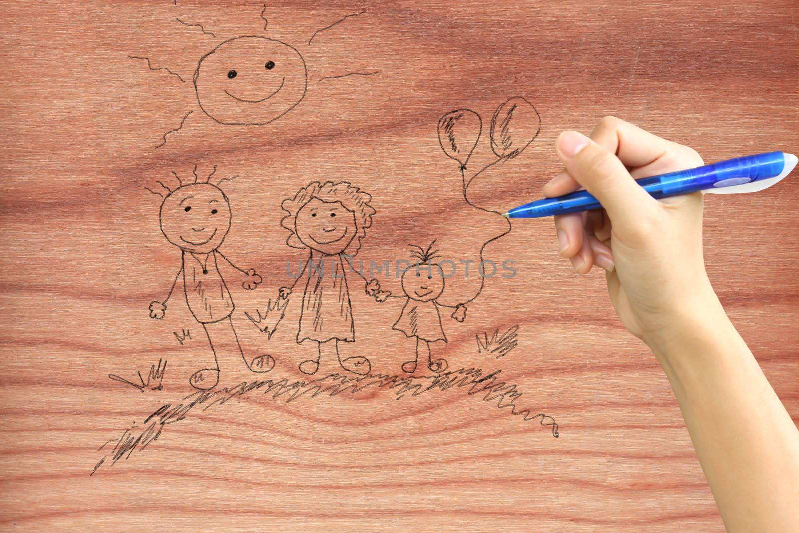 Hand drawing a happy family on wood by rufous