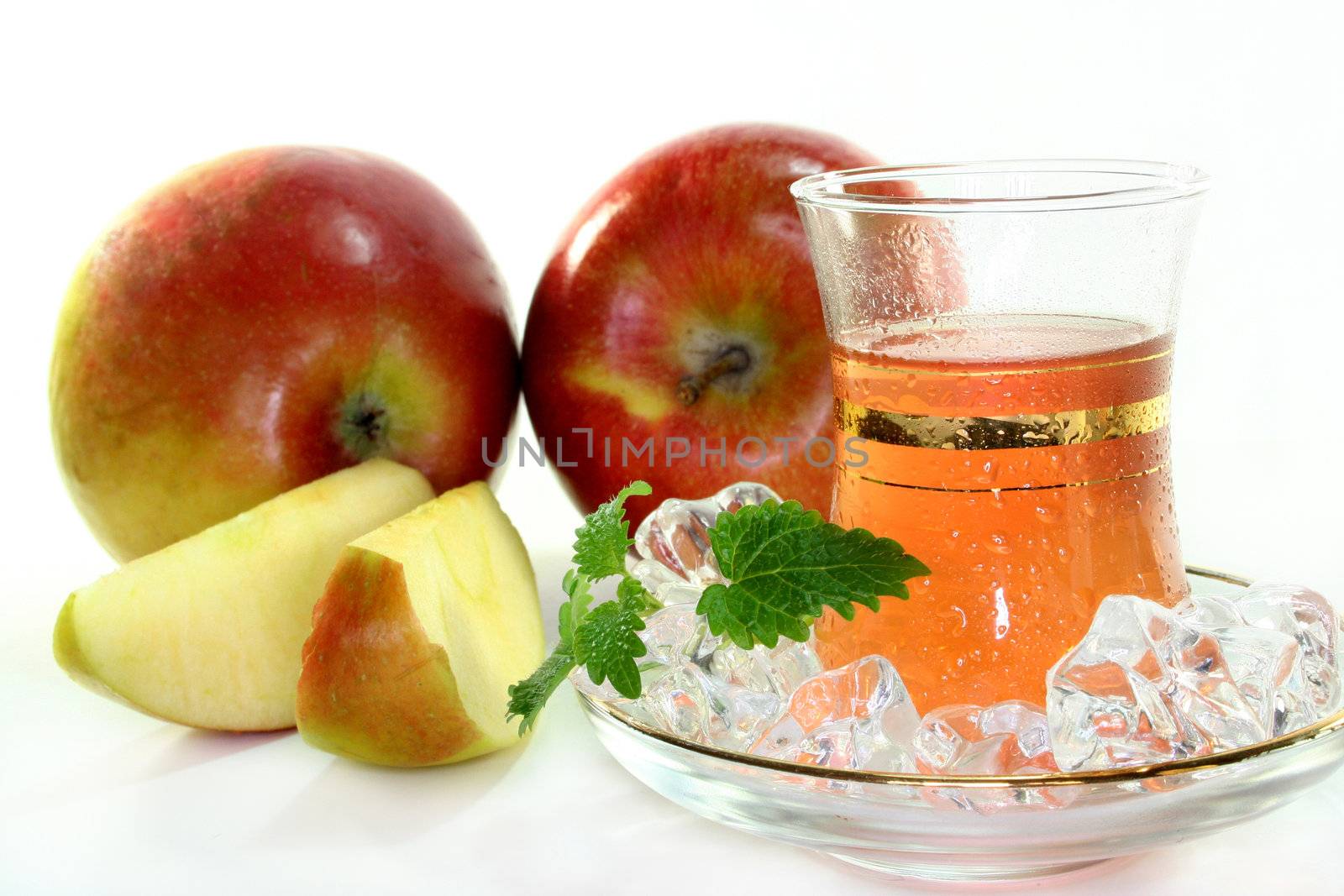 a cup of apple tea with fresh apple and lemon balm