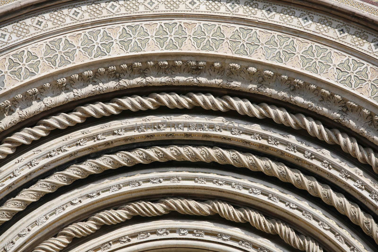 Detail of the facade of Orvieto Cathedral. (1290 - 1600 a. c.) Richly decorated with lots of stone mosaics and reliefs as well as pattern and artistic coils all over the facade.