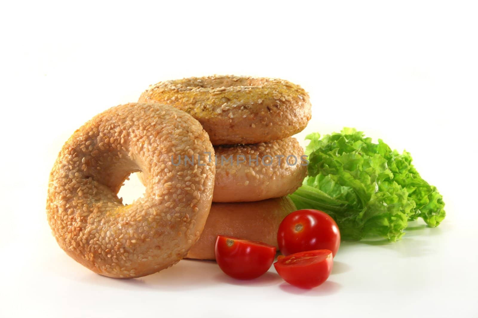 different bagel with a lettuce leaf and tomato