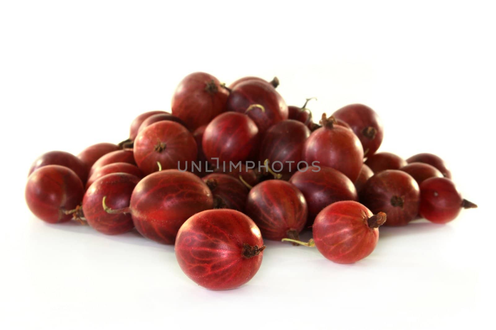 a handful of gooseberries on a white background