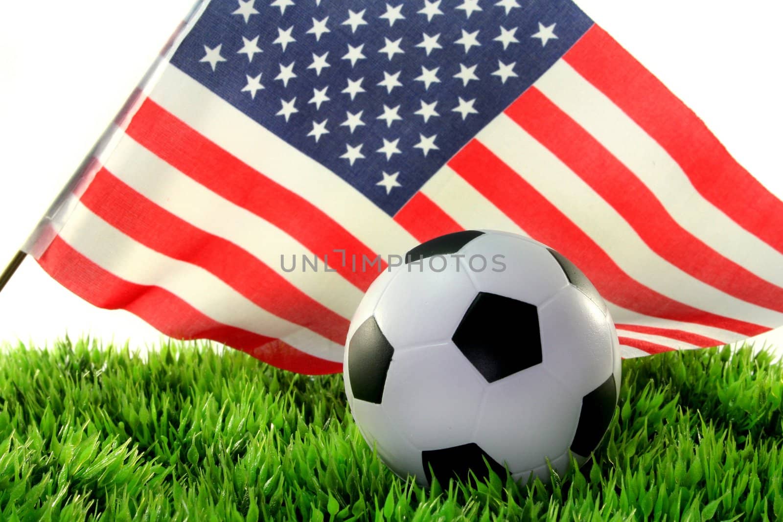 a ball and a national flag on a piece of grass