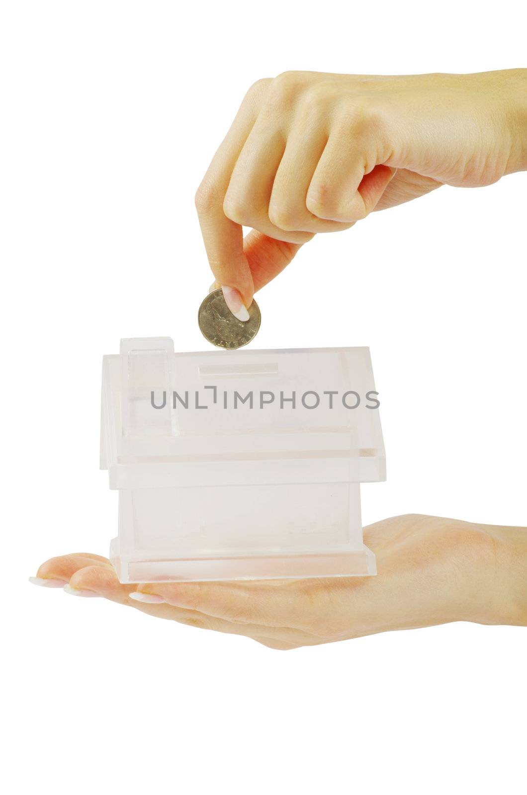 Hand with coin and house bank isolated on white background