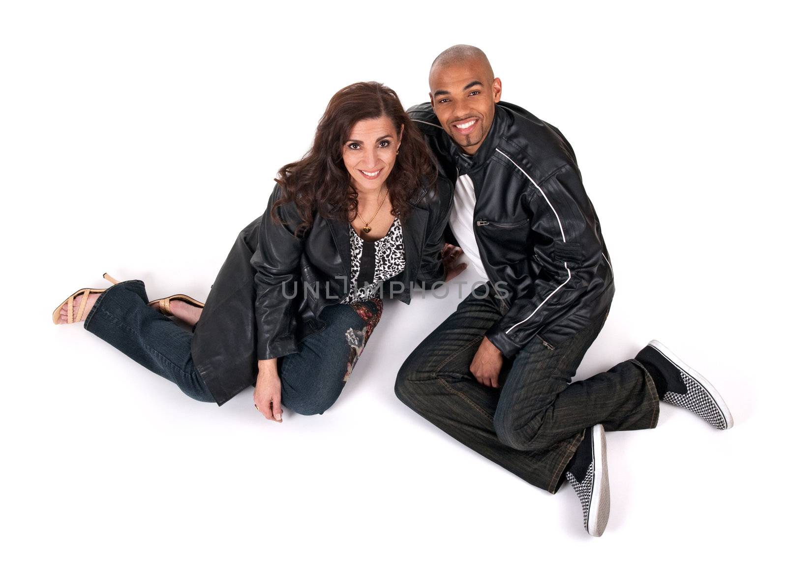 Happy man and woman sitting close to each other and smiling.