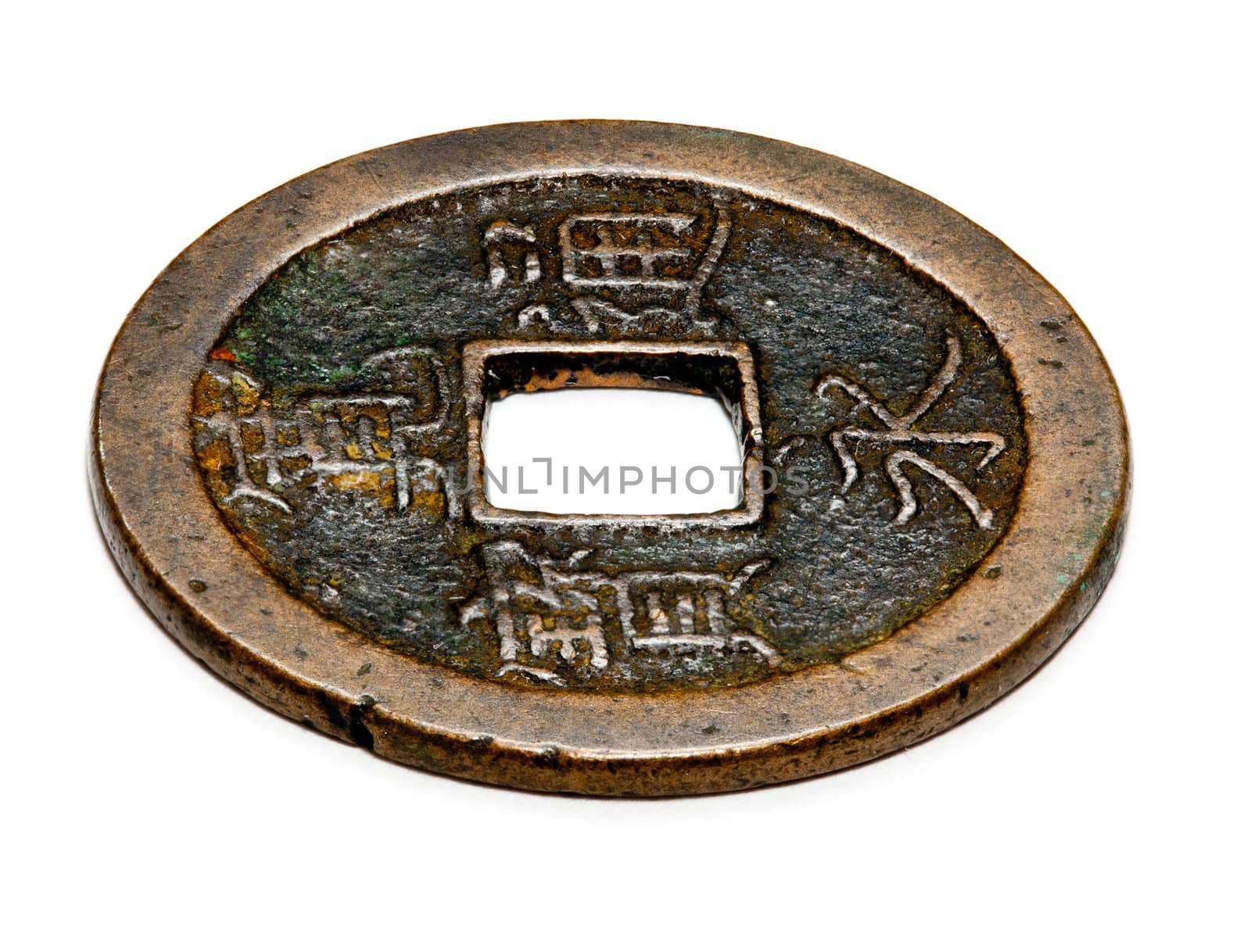 Macro image of an antique chinese coin with a square hole in the center isolated against white