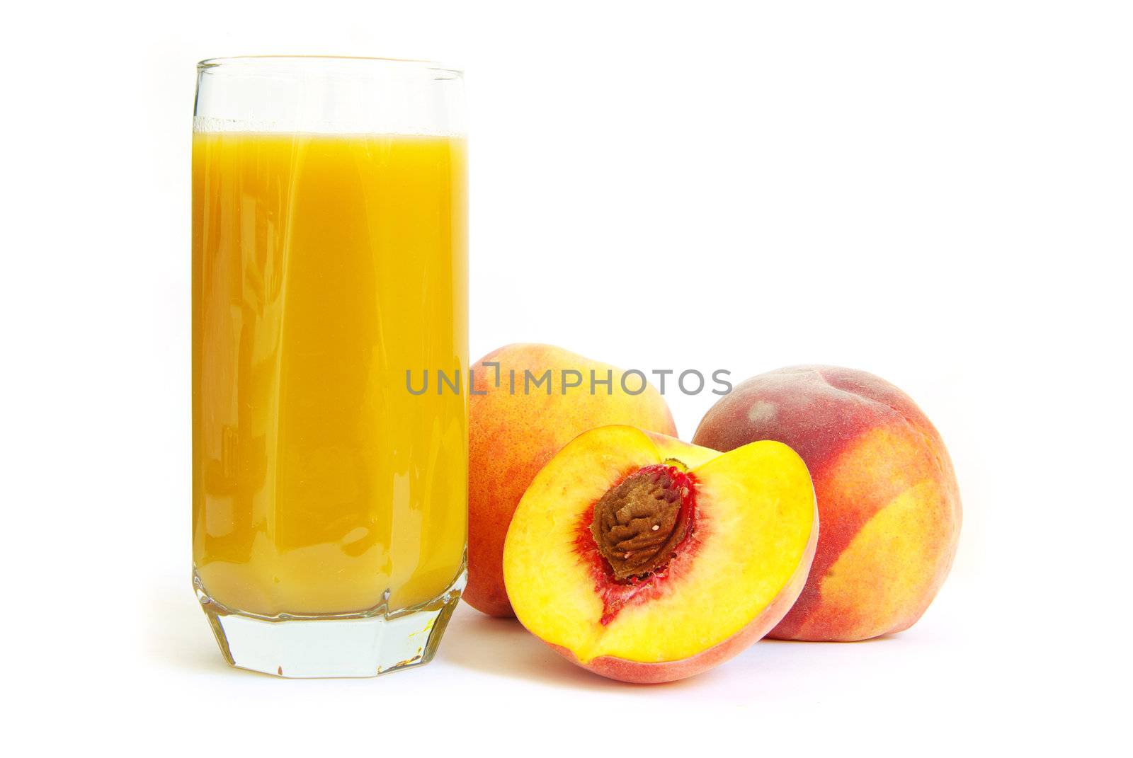 Glass with freshly made peach juice on a white background