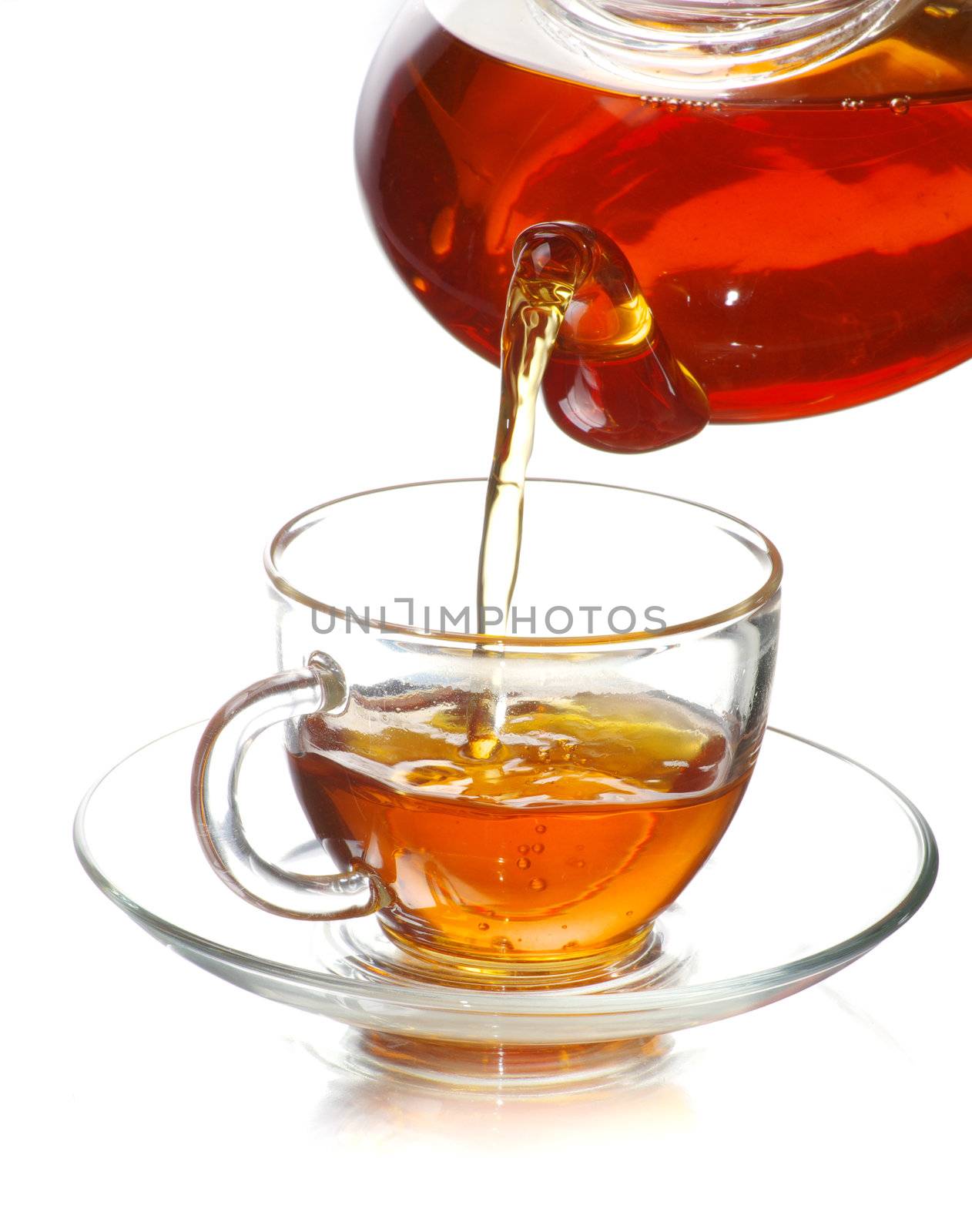 Tea being poured into glass tea cup