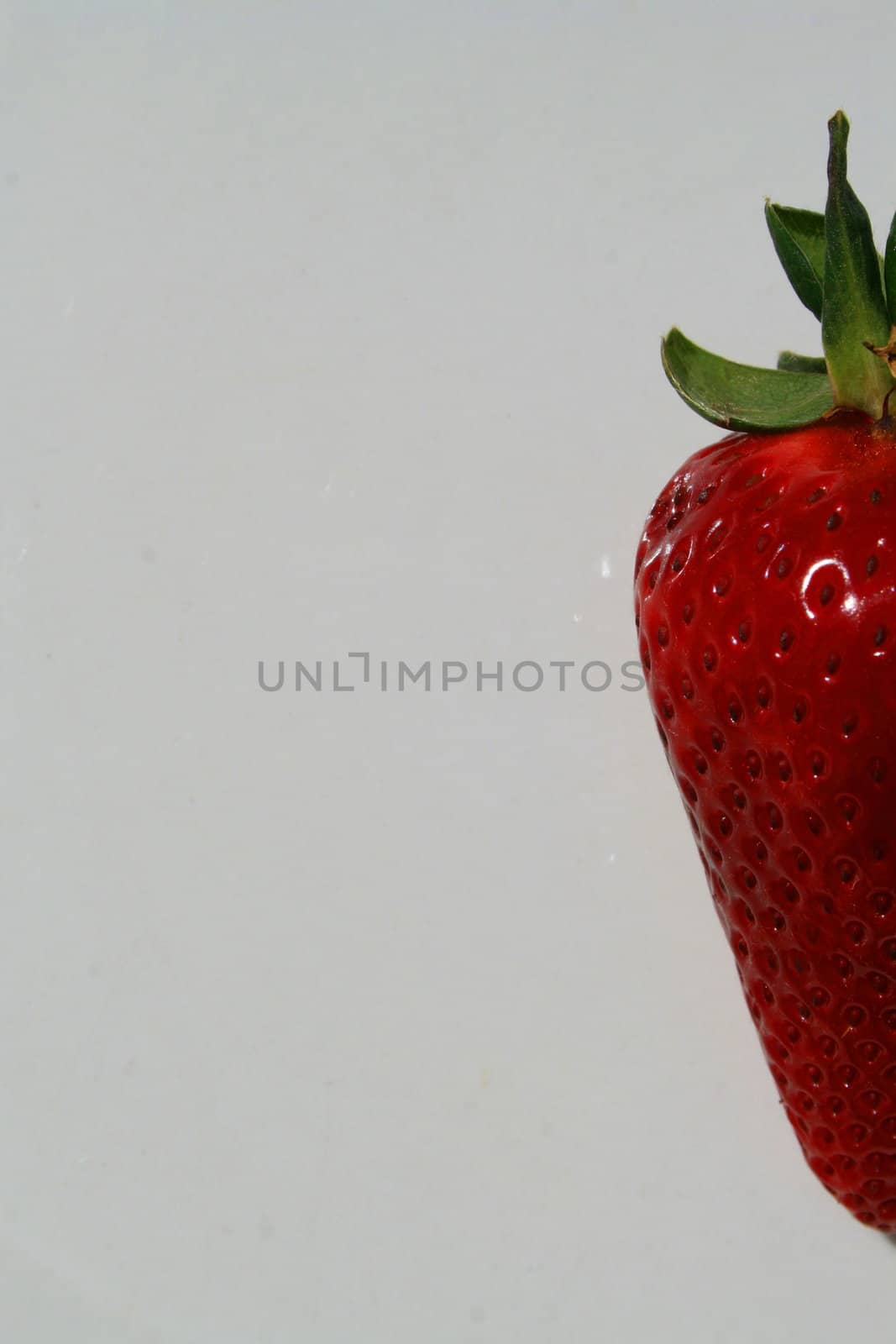 Close up of a strawberry on a plate.
