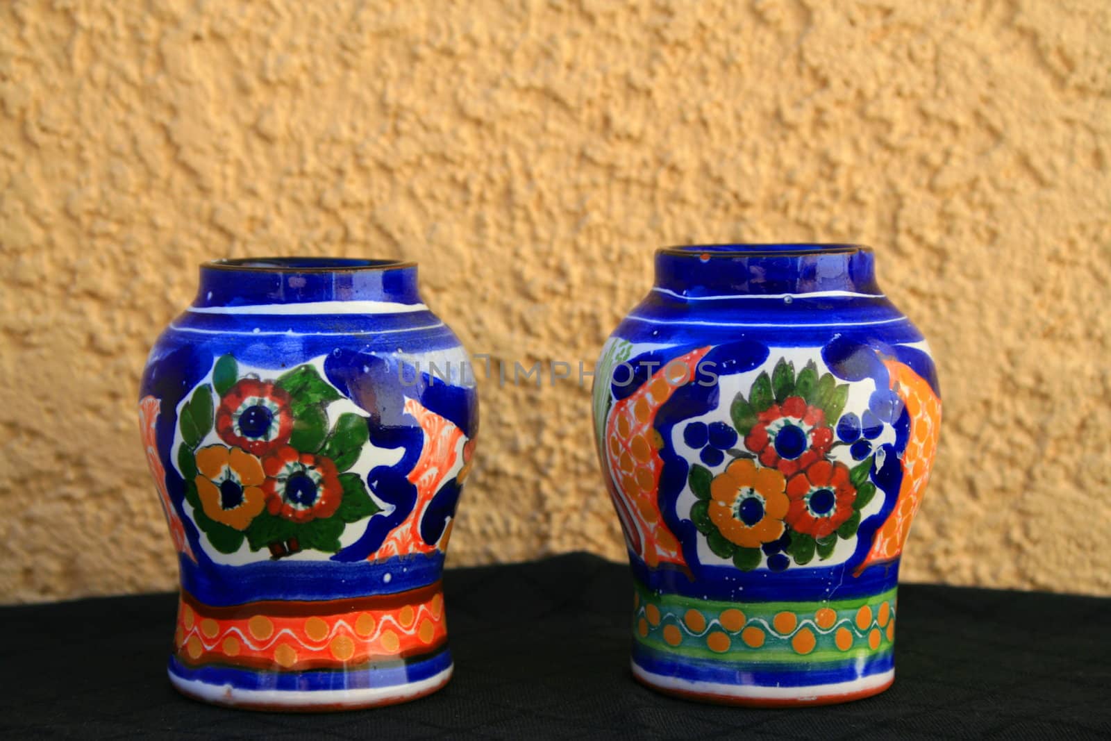 Talavera handpainted pottery over cream and black background