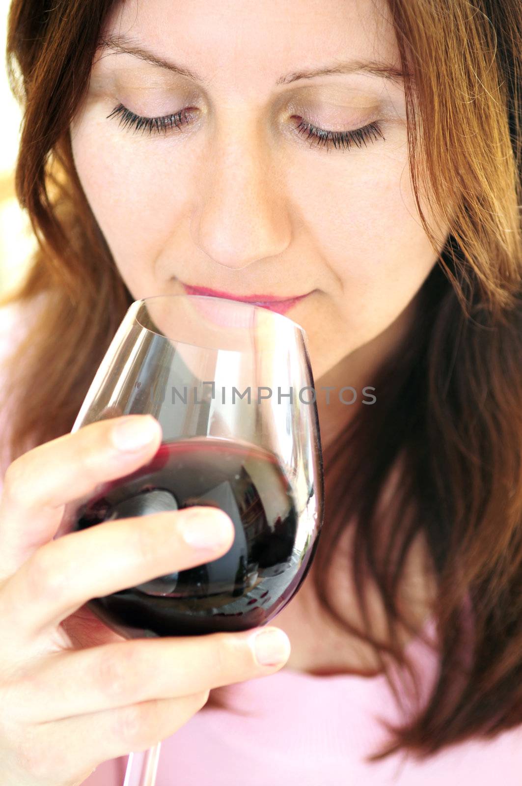 Mature woman holding a glass of red wine