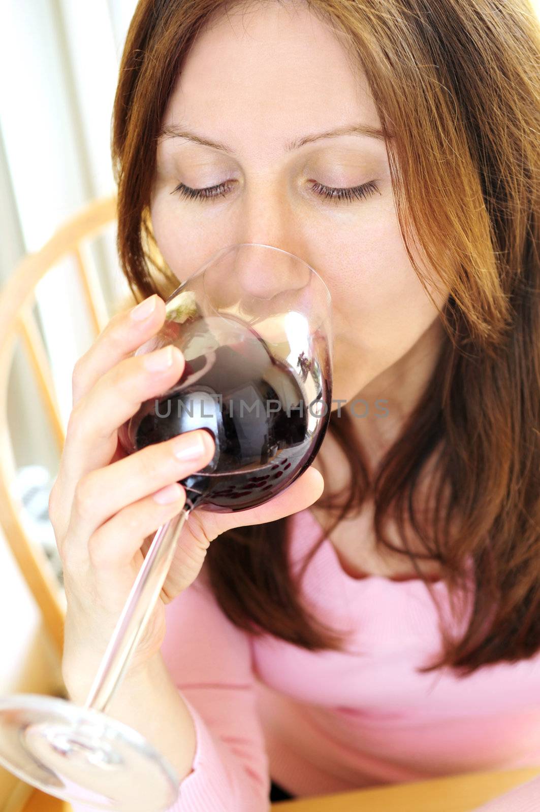 Mature woman holding a glass of red wine