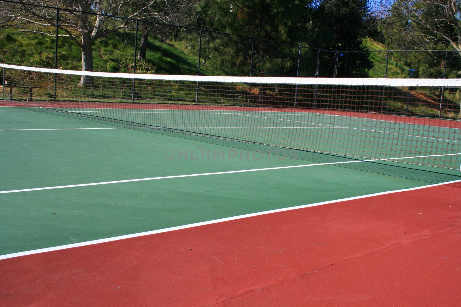 Tennis court during day time in a park.