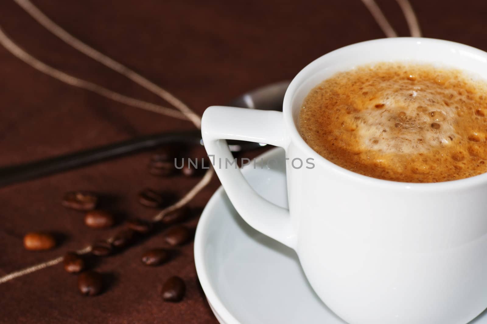 A cup of espresso coffee in a white cup and saucer