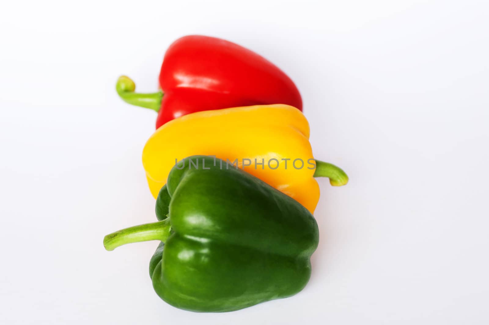 Red green and yellow peppers arranged like a traffic light