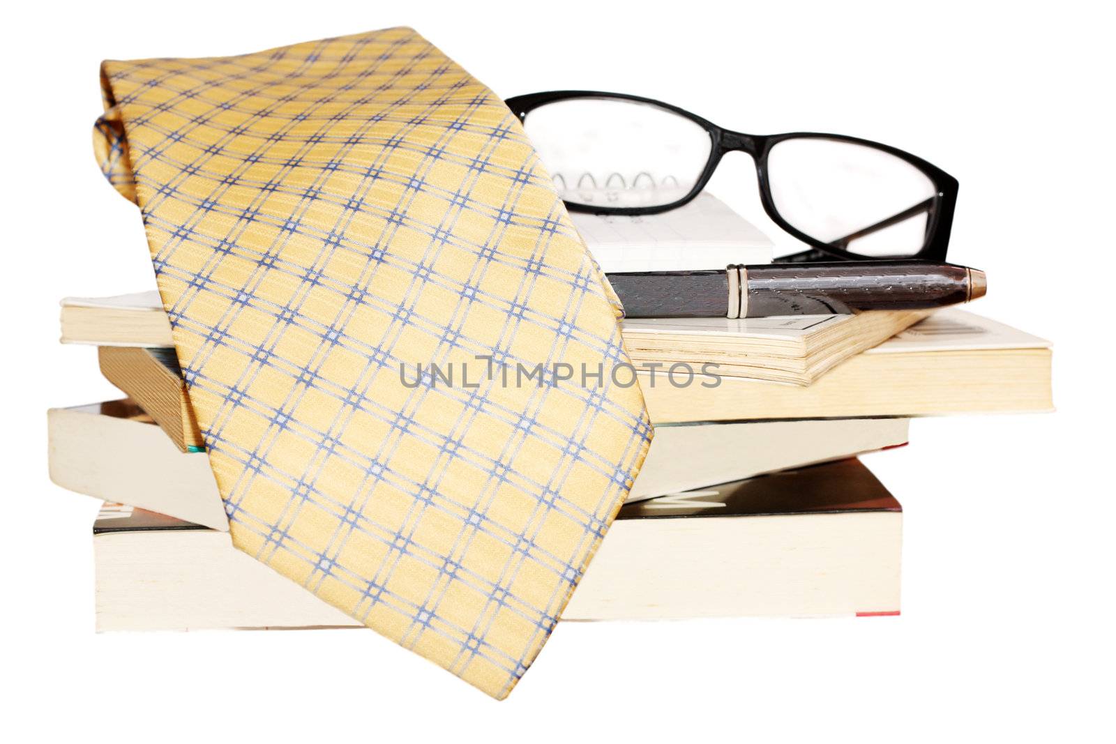 Pen, lens, pile of books and tie