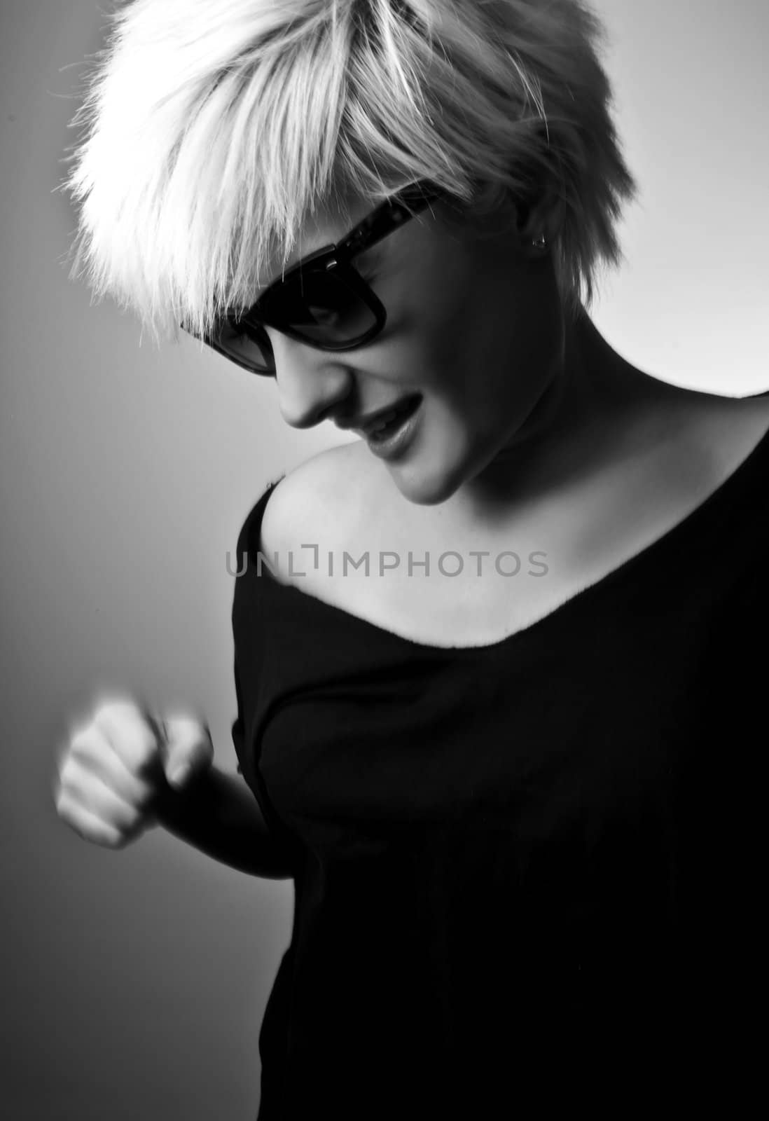 Portrait of a young, blonde girl with short hair and sunglasses