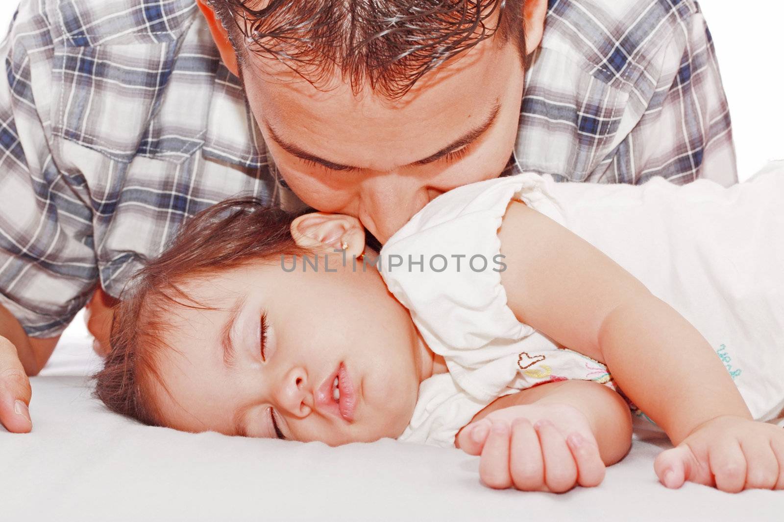 Father kissing his baby sleeping by dacasdo