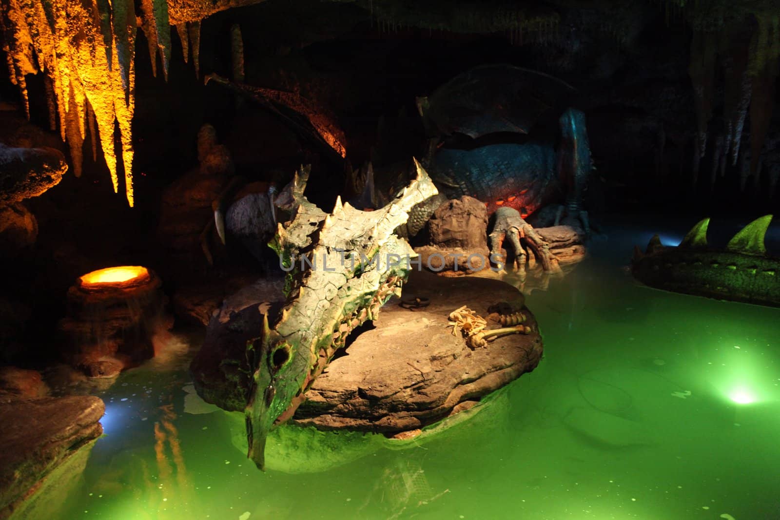 A Dragon asleep in a cave with green water