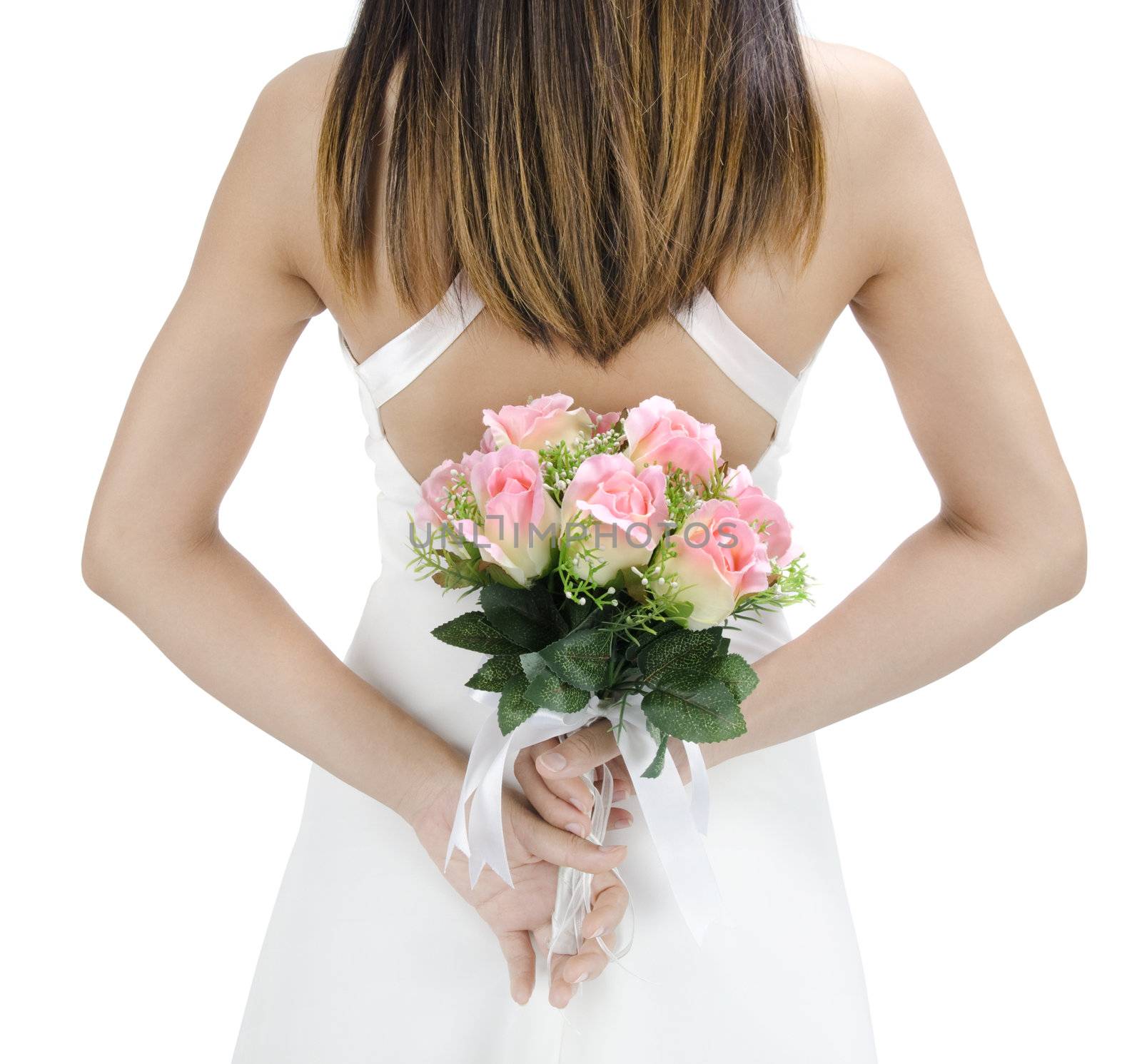 Bride holding her bouquet behind her back