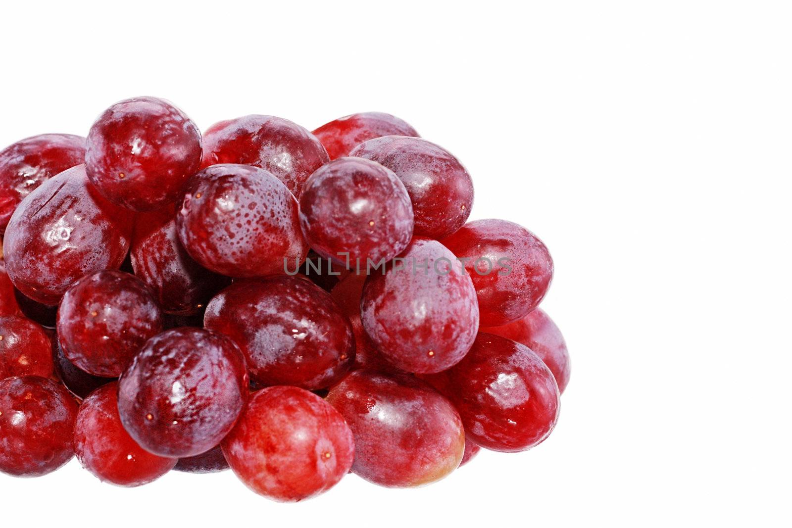 Perfect bunch of red grapes isolated on white background by dacasdo