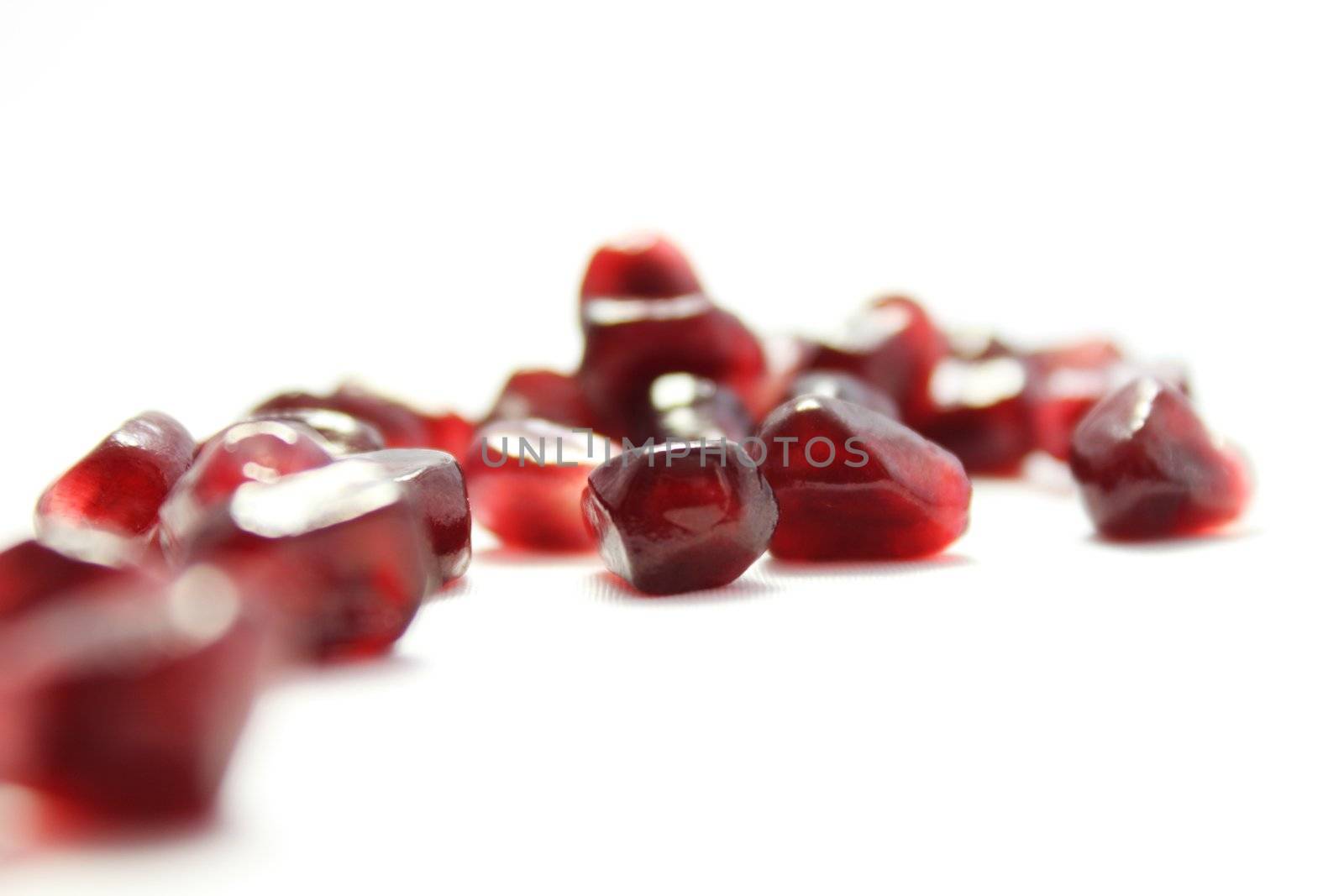 ruby grain garnet is spilt on white background