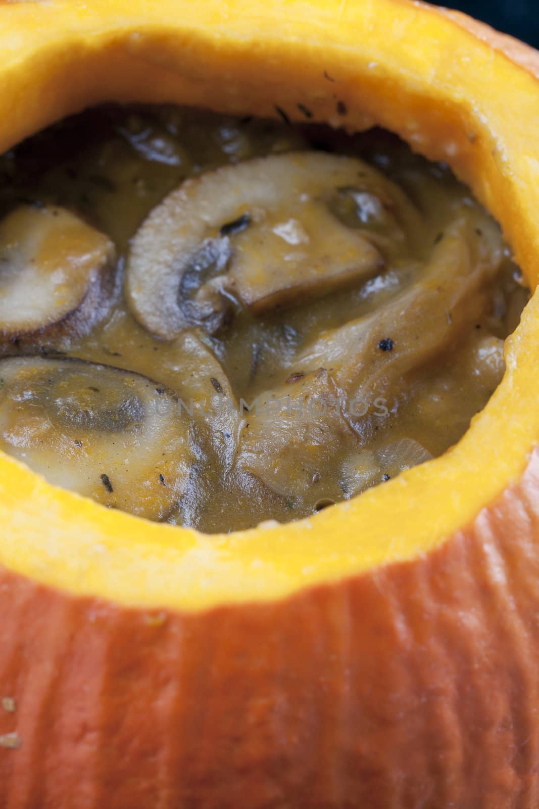 Creamy mushroom soup in a pumpkin bowl.