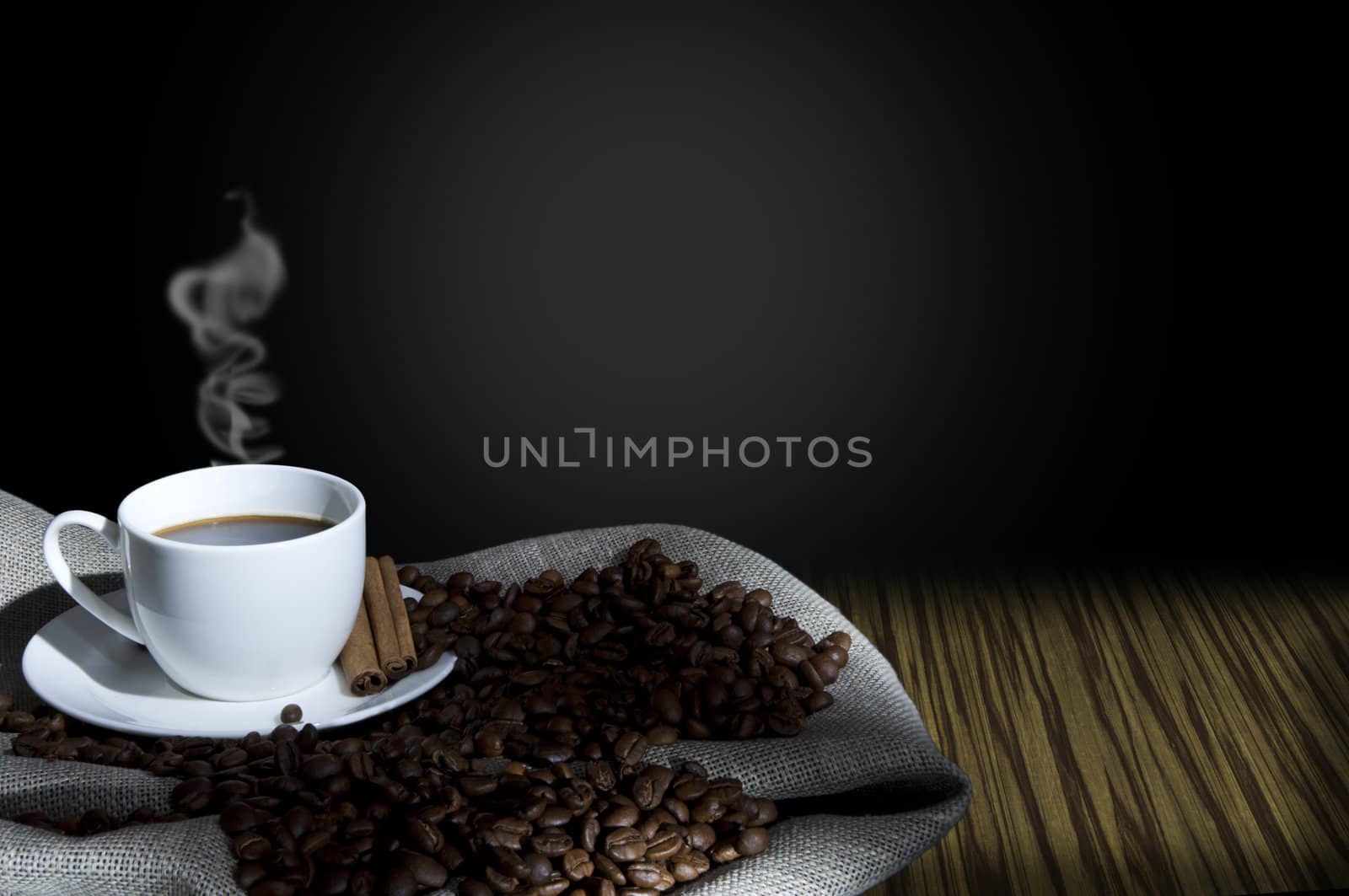 cup of coffee and coffee beans on the Sacking, abstract grunge background