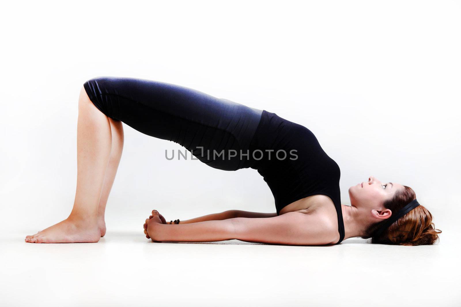 Pretty girl on white background prectice yoga