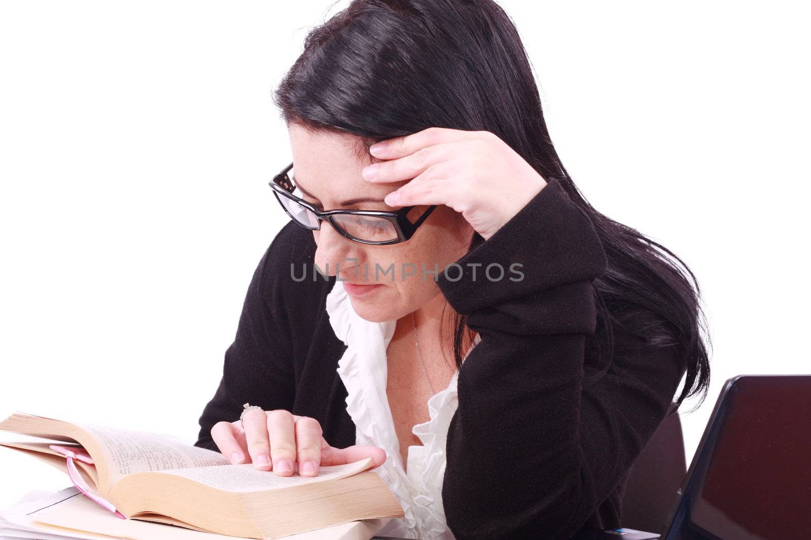 Beautiful young business woman reads the book in office by dacasdo