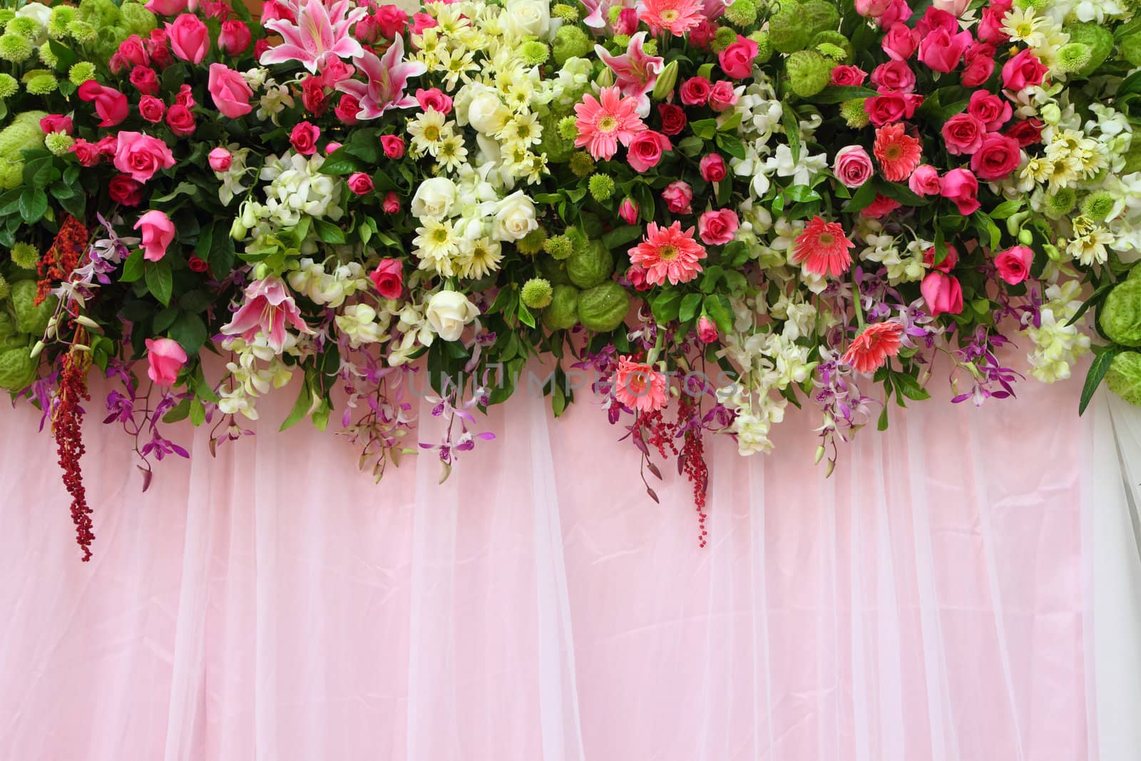 exotic flowers arrangement over pink fabric, flowers background.